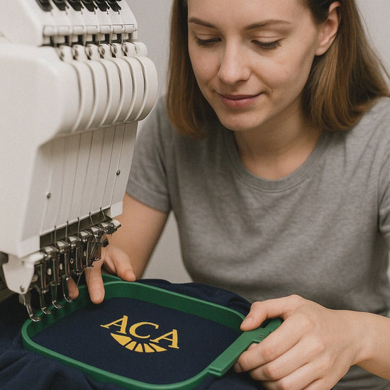 Woman holding custom embroidered unisex polo shirt with business logo – navy blue.

