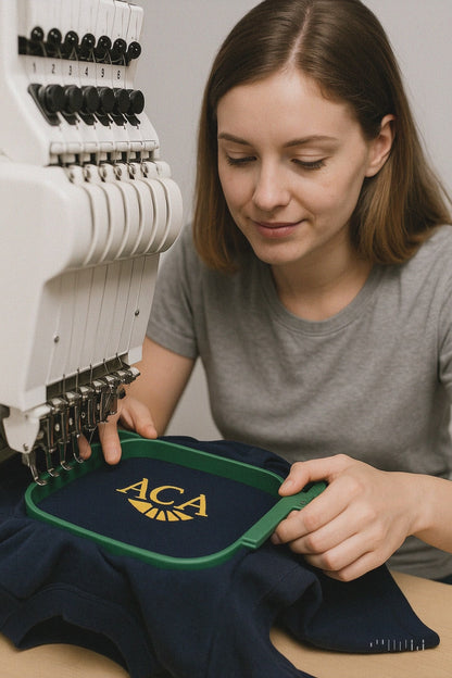 Woman holding custom embroidered unisex polo shirt with business logo – navy blue.

